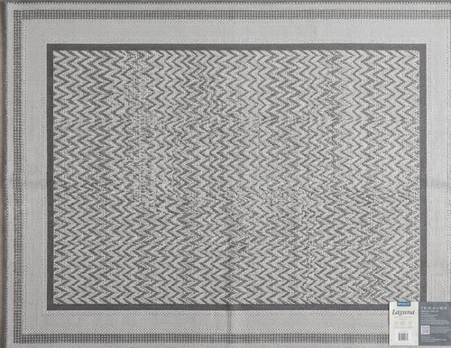 Gray and white patterned rug with a brand label on a beige background